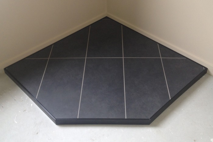 Custom tile, corner hearth, black metal trim